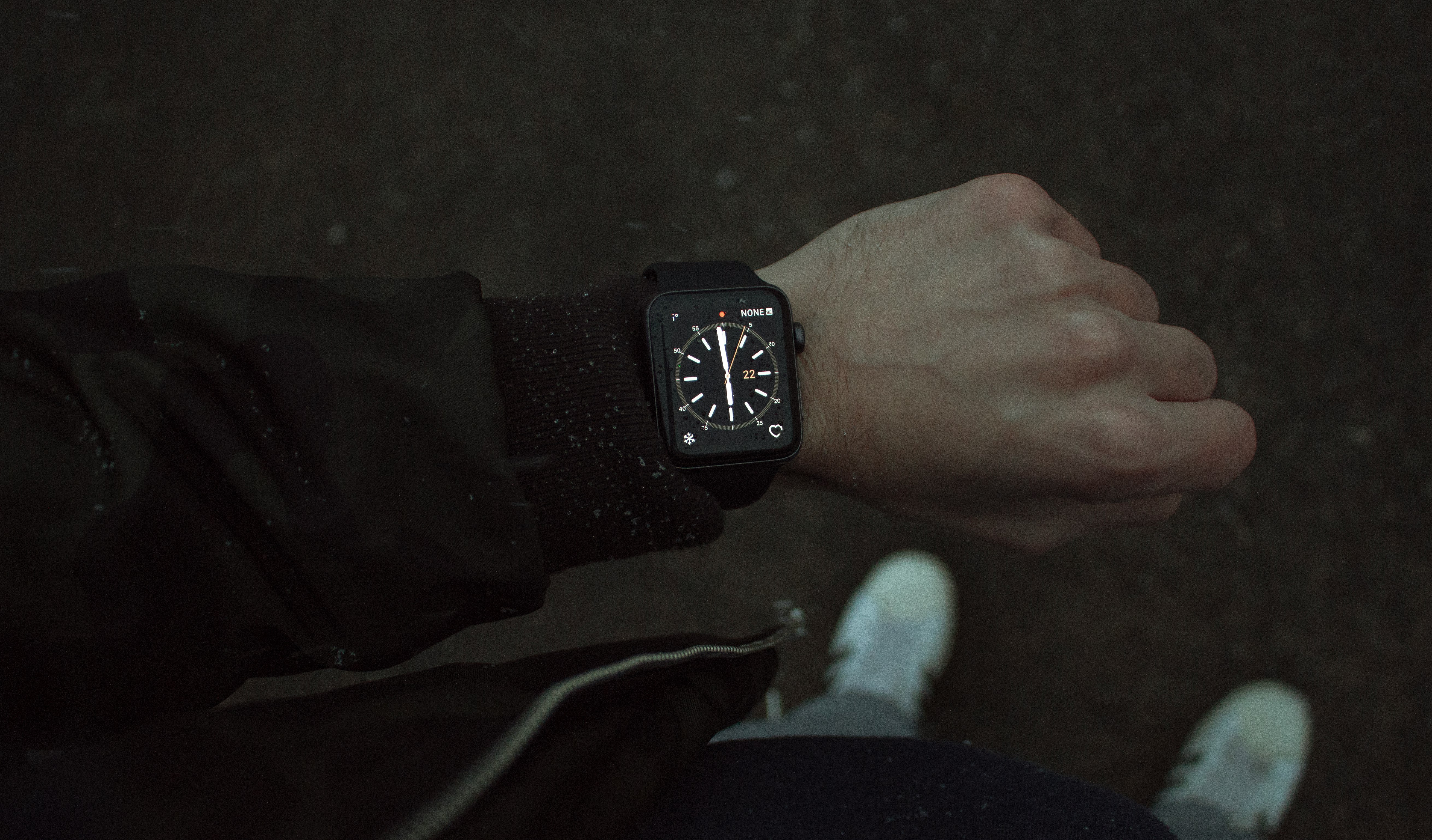 person wearing space black Apple Watch with black strap